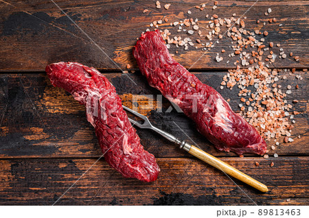 Uncooked raw Machete skirt steak on meat fork. Wooden background. Top view 89813463