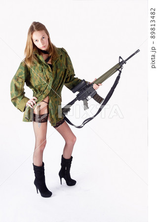 Pretty woman with gun and knife over white Pretty woman with gun and knife over white 89813482