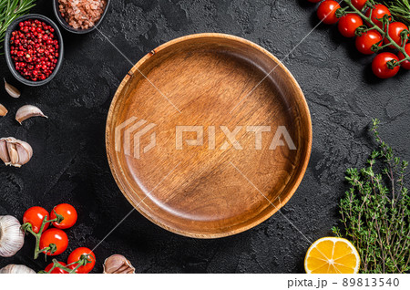 Healthy eating vegan food concept background with empty plate and fresh seasoning, herbs and ingredients. Black background. Top view. Copy space 89813540