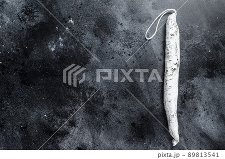 Spanish salami fuet sausage on a kitchen table. Black background. Top view. Copy space Spanish salami fuet sausage on a kitchen table. Black background. Top view. Copy space 89813541