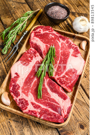 Fresh Raw Black Angus prime beef chuck eye roll steaks. wooden background. Top view Fresh Raw Black Angus prime beef chuck eye roll steaks. wooden background. Top view 89813545