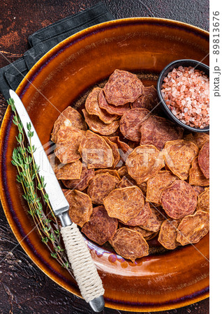 Dried smoked Meat Jerky from beef and pork meat. Dark background. Top view 89813676