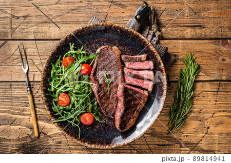BBQ Grilled cup rump beef meat steak in plate with vegetable salad. Wooden background. Top view BBQ Grilled cup rump beef meat steak in plate with vegetable salad. Wooden background. Top view 89814941