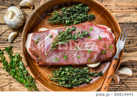 Raw uncooked poultry duck meat breast fillet with herbs. wooden background. Top view 89814945