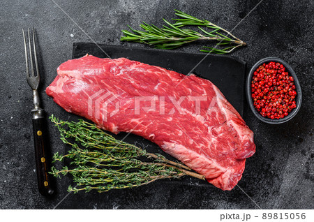 Raw flank beef meat steak. Black background. Top view 89815056