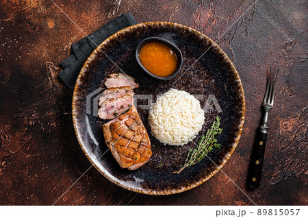 Roasted Duck breast steak, poultry fillet meat with sauce and rice. Dark background. Top view Roasted Duck breast steak, poultry fillet meat with sauce and rice. Dark background. Top view 89815057