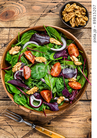 Fresh vegetable green salad with leaves mangold, swiss chard, spinach, arugula and nuts. wooden background. Top view Fresh vegetable green salad with leaves mangold, swiss chard, spinach, arugula and nuts. wooden background. Top view 89815207