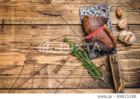 Grilled rump cap or brazilian picanha beef meat steak on a cleaver. wooden background. Top view. Copy space Grilled rump cap or brazilian picanha beef meat steak on a cleaver. wooden background. Top view. Copy space 89815286