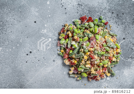 Assortment of frozen vegetables and quinoa with ice. Gray background. Top view. Copy space Assortment of frozen vegetables and quinoa with ice. Gray background. Top view. Copy space 89816212