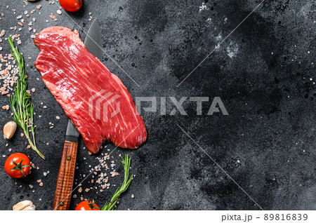 Raw Flank steak black Angus. Fresh Marble beef meat. Black background. Top view. Copy space Raw Flank steak black Angus. Fresh Marble beef meat. Black background. Top view. Copy space 89816839