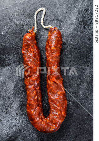 Spanish chorizo pork cured sausage. Black background. Top view Spanish chorizo pork cured sausage. Black background. Top view 89817222