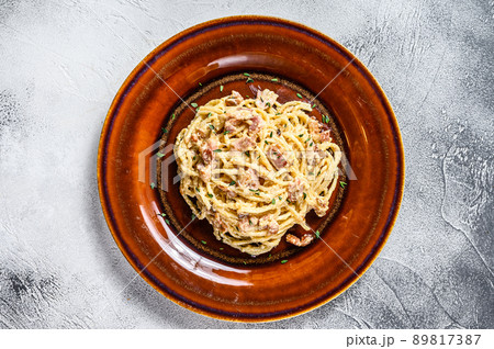 Italian Spaghetti Carbonara pasta with bacon, hard parmesan cheese and cream sauce. White background. top view 89817387