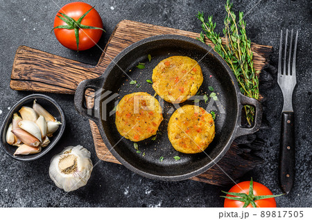 Baked vegetables patties cutlets for vegan burgers. Dark background. Top view Baked vegetables patties cutlets for vegan burgers. Dark background. Top view 89817505
