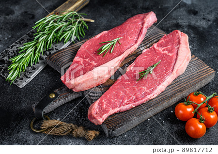 Raw top sirloin cap or picanha steak. Black background. Top view Raw top sirloin cap or picanha steak. Black background. Top view 89817712