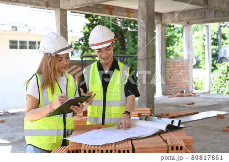Two inspectors or engineer working and discussing about construction project together 89817861