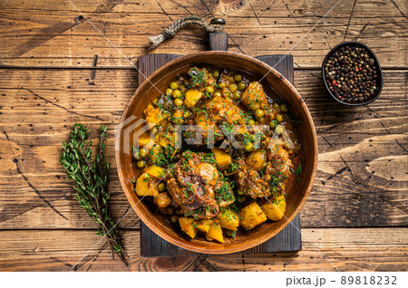 Lamb oxtails tails stew with vegetables in a wooden plate. wooden background. Top view 89818232