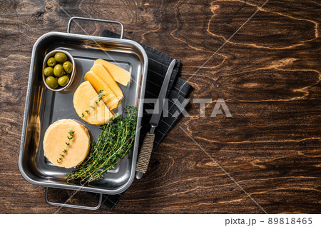 Fresh Halloumi sliced cheese in kitchen tray with thyme. Wooden background. Top view. Copy space Fresh Halloumi sliced cheese in kitchen tray with thyme. Wooden background. Top view. Copy space 89818465
