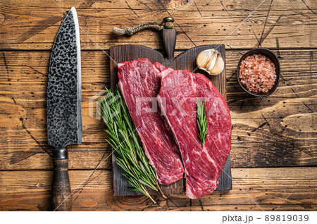 Raw rump cap steak or Picanha steak on wooden board with butcher knife. wooden background. Top view Raw rump cap steak or Picanha steak on wooden board with butcher knife. wooden background. Top view 89819039