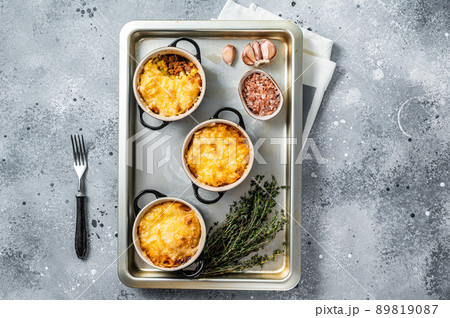 Irish Shepherd's pie with mince meat, mashed potato and cheddar cheese crust. Gray background. Top view 89819087