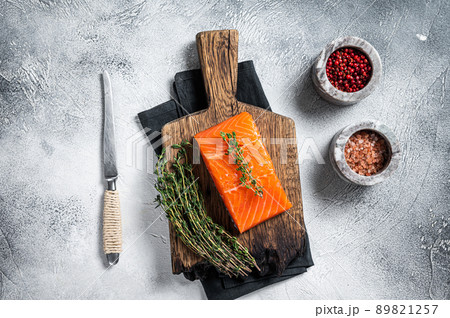 Fresh Raw salmon fillet steak on wooden board. White background. Top view 89821257