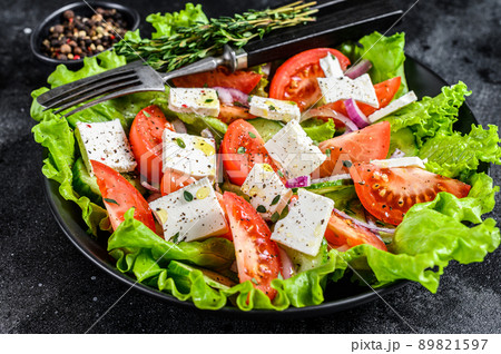 Bowl of ready-to-eat Greek salad. Black background. Top view 89821597
