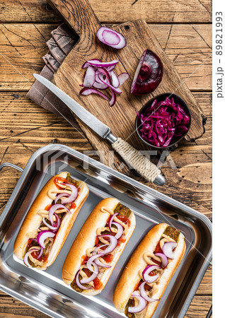 Vegan Vegetarian hot-dogs with onion and meatless sausage. Wooden background. Top view Vegan Vegetarian hot-dogs with onion and meatless sausage. Wooden background. Top view 89821993