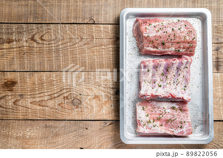 Set of Raw pork cuts, loin meat, spare ribs and brisket. Wooden background. Top view. Copy space Set of Raw pork cuts, loin meat, spare ribs and brisket. Wooden background. Top view. Copy space 89822056