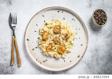 Italian Risotto with pan seared sea scallops. White background. Top view 89822069