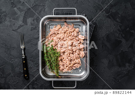 Tuna canned fish with olive oil in a tray . Black background. top view 89822144