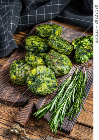 Roasted vegetarian broccoli and pea vegetable patty or cutlet, falafel. wooden background. Top view Roasted vegetarian broccoli and pea vegetable patty or cutlet, falafel. wooden background. Top view 89822180