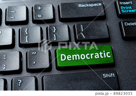 Democratic green key on a black desktop keyboard. Concept of voting online. Democratic green key on a black desktop keyboard. Concept of voting online. 89823035