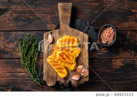 Fried on grill Halloumi cheese with herbs and thyme. Wooden background. Top view Fried on grill Halloumi cheese with herbs and thyme. Wooden background. Top view 89823315