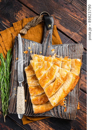 Homemade greek spanakopita pie with organic cheese on wooden board. Wooden background. Top view 89823790