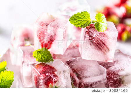 Strawberries frozen in ice cubes with mellisa leaves Strawberries frozen in ice cubes with mellisa leaves 89824166