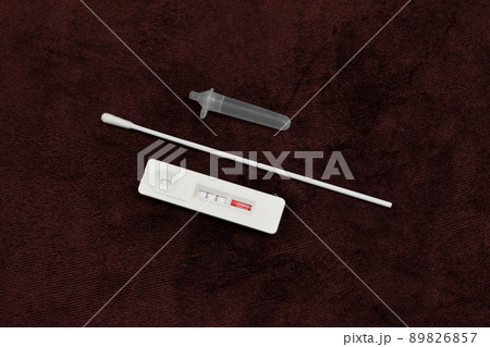 Antigen test kit (ATK) Covid-19 positive test result on dark red color background 89826857