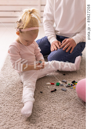 Happy child girl with cochlear implant having fun with her father - hearing aid for deaf and innovative health technology and diversity concept Happy child girl with cochlear implant having fun with her father - hearing aid for deaf and innovative health technology and diversity concept 89827208