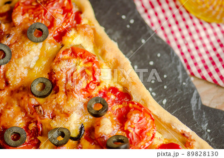 Homemade pizza on a wooden background 89828130