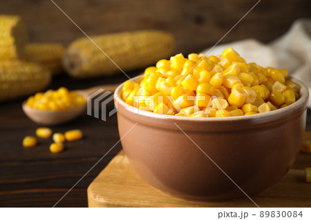 Delicious canned corn in bowl on wooden table, closeup Delicious canned corn in bowl on wooden table, closeup 89830084
