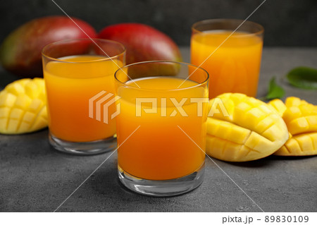 Fresh delicious mango drink on grey table 89830109