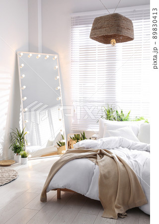 Stylish mirror with light bulbs in modern bedroom. Interior design 89830413