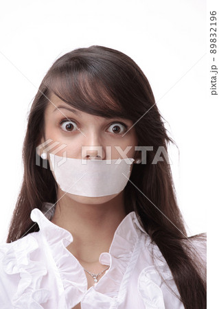 portrait of young business woman with taped mouth 89832196