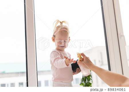 Baby with cochlear implants at home. Deafness and medical technology concept. 89834061