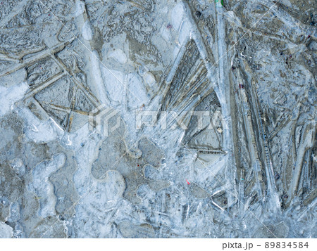 Frozen puddle on the asphalt.Abstract winter background Frozen puddle on the asphalt.Abstract winter background 89834584