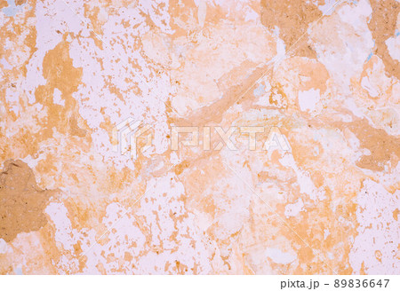 Background from a clay wall covered with crumbling lime and old paint. 89836647