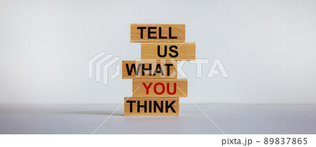 Wooden blocks with text 'tell us what you think'. Beautiful white background, copy space. Business concept. 89837865