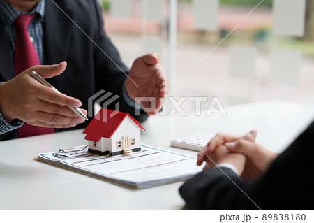 Close up of Business man pointing and signing agreement for buying house. Bank manager concept. 89838180