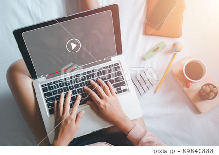 Video streaming on internet, Woman watching online movie or TV series on laptop computer, Concept about subscription based live digital stream. 89840888