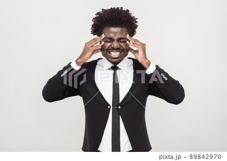 Sick afro man have a headache and migreine. Studio shot, gray background 89842970