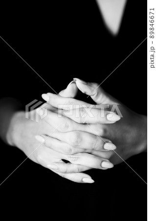 Young, well-groomed women's hands in a black and white photo. Vertical photo. Young, well-groomed women's hands in a black and white photo. Vertical photo. 89846671