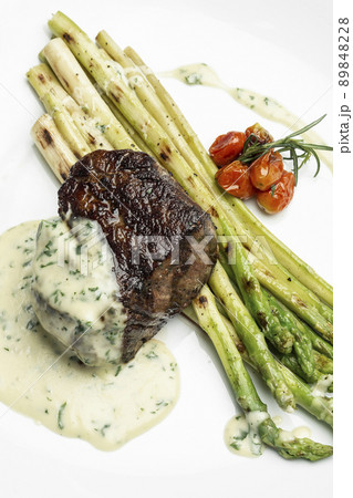 grilled filet mignon tenderloin steak with asparagus and creamy dill sauce grilled filet mignon tenderloin steak with asparagus and creamy dill sauce 89848228